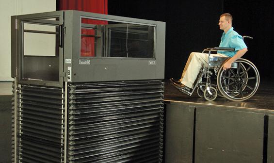 Man using Ascension Virtuoso vertical wheelchair lift to exit a stage